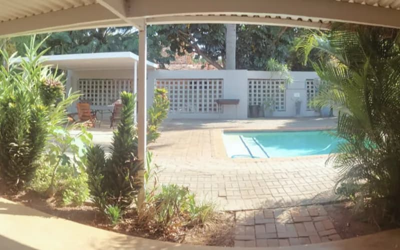 The Wilds Guest House pool area at sunset
